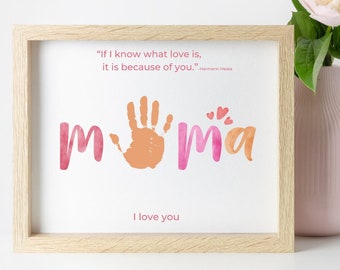 May include: A framed print with a watercolor design of the word "mama" with a handprint in the middle. The quote "If I know what love is, it is because of you." - Hermann Hesse is printed above the design. The words "I love you" are printed below the design.