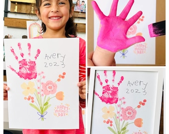 May include: A pink handprint art project with a bouquet of flowers and the text "Avery 2023" and "Happy Mother's Day".