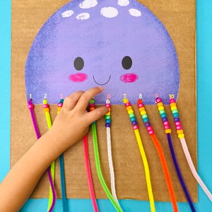 May include: A purple jellyfish with a smiling face and ten colorful pipe cleaner tentacles. Each tentacle has a string of colorful beads with numbers 1 through 10.