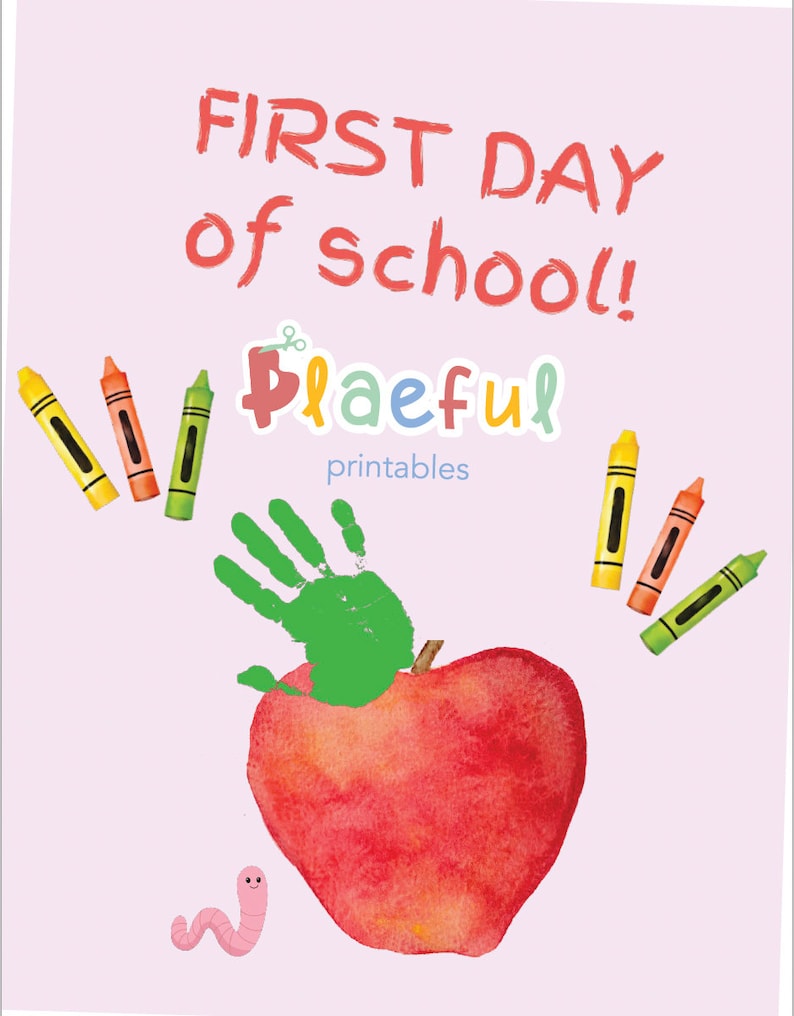 May include: A red apple with a green handprint on top. The text "FIRST DAY of school!" is written in red at the top of the image. The text "Playful printables" is written in blue and pink at the bottom of the image. There are crayons in the image.