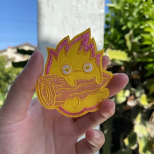 Howl’s Moving Castle Inspired Frowning Calcifer the Fire Demon Hanging Off a Wooden Log Iron-On/Sew-On Embroidered Patch