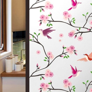 May include: A white background with a decorative design of pink flowers and pink and red birds on branches.