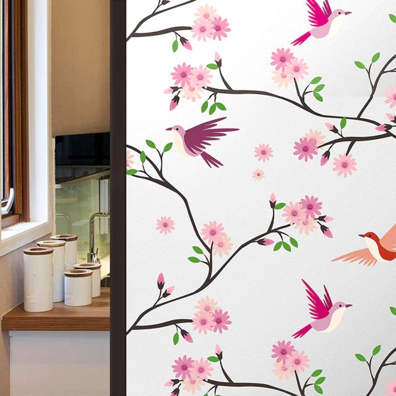 May include: A white background with a decorative design of pink flowers and pink and red birds on branches.