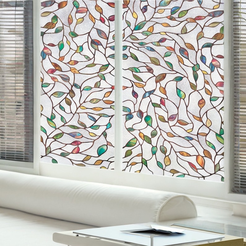 May include: A stained glass window film with a design of colorful leaves and branches. The film is translucent and allows light to pass through.
