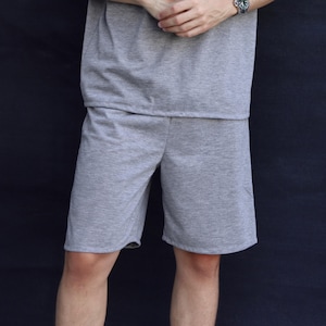 May include: A light gray shorts set. The shorts are knee-length and made of a soft, comfortable material. The matching top is visible at the top of the image. The set is suitable for casual wear.