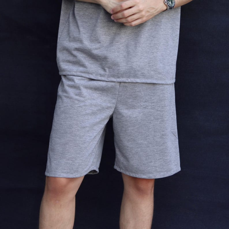 May include: A light gray shorts set. The shorts are knee-length and made of a soft, comfortable material. The matching top is visible at the top of the image. The set is suitable for casual wear.