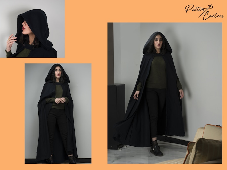 May include: A black hooded cape with a long flowing design. The cape is being worn by a person with dark hair and a green shirt. The person is standing in a room with a white wall and a grey floor.