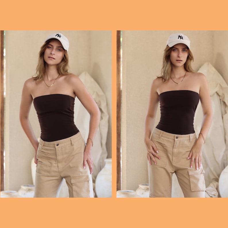 May include: A woman wearing a brown strapless top and beige cargo pants. She is wearing a white baseball cap with a black logo.
