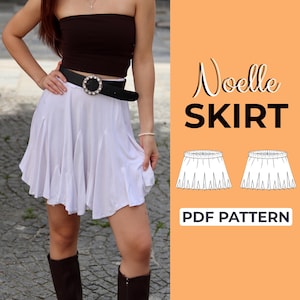 May include: A white skirt with a ruffled hem, paired with a black belt featuring a large, decorative buckle. The image also includes a brown tube top and knee-high boots. Text on the right reads "Noelle SKIRT" and "PDF PATTERN".