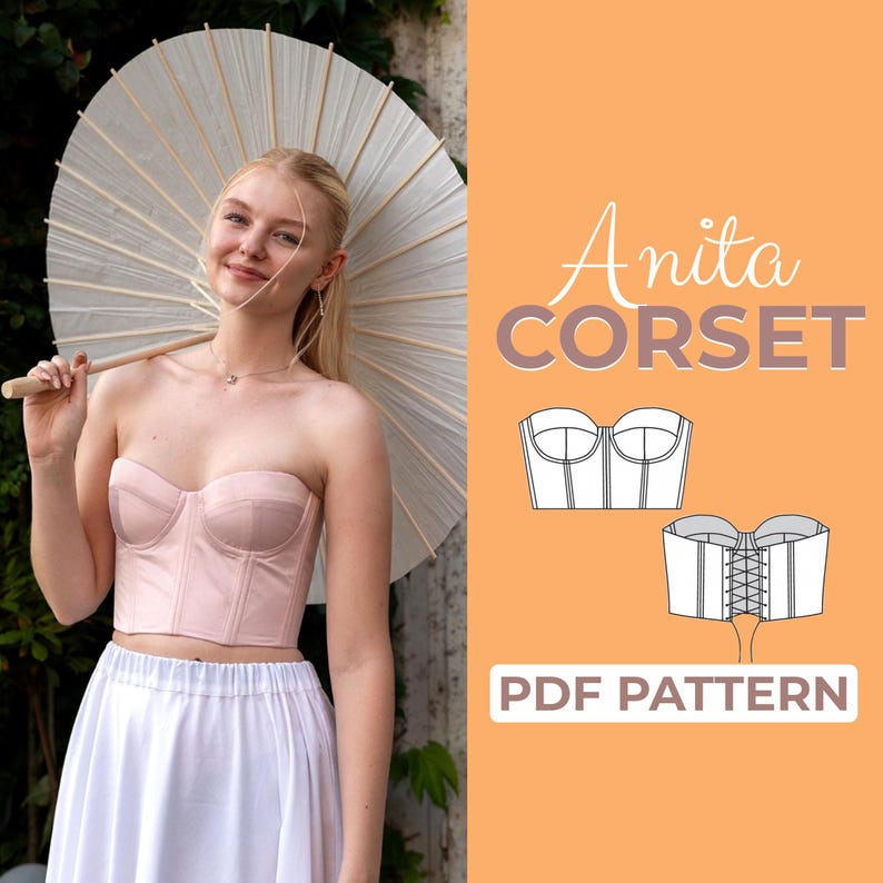 K&ouml;nnte beinhalten: Ein tr&auml;gerloses, hellrosa Korsett mit herzf&ouml;rmigem Ausschnitt. Das Bild zeigt auch einen wei&szlig;en Sonnenschirm, einen wei&szlig;en Rock und den Text "Anita CORSET PDF PATTERN" in einer stilisierten Schriftart auf orangefarbenem Hintergrund.