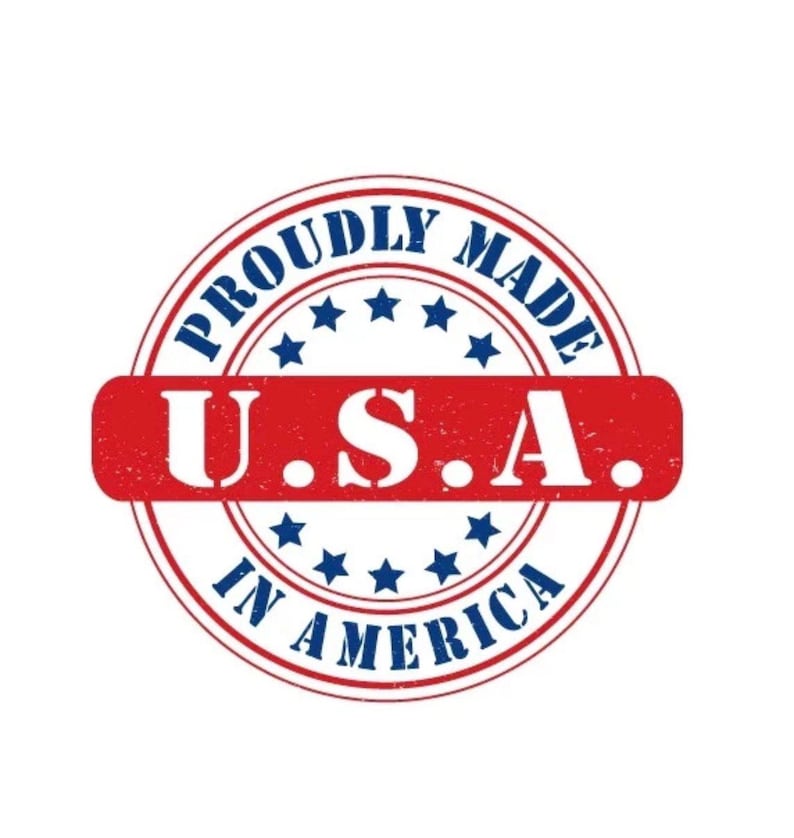 May include: A circular emblem with the text "PROUDLY MADE IN AMERICA" in a blue ring around the edge. The center features a red rectangle with "U.S.A." in white. Blue stars are interspersed.