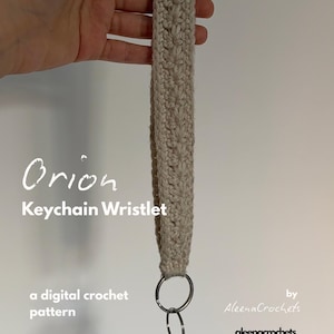 May include: A beige crochet keychain wristlet with a silver ring and keys attached. The wristlet is held up by a hand. Text on the image reads "Orion Keychain Wristlet" and "a digital crochet pattern".