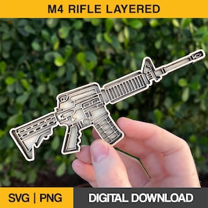 May include: A layered wooden cutout of an M4 rifle. The rifle is shown in a light brown color and is held in a person's hand. The image is labeled "M4 RIFLE LAYERED" and "SVG | PNG | DIGITAL DOWNLOAD".