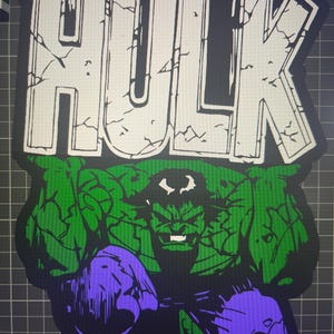 May include: A green and purple Hulk character graphic with the word "HULK" in white letters with a cracked background.