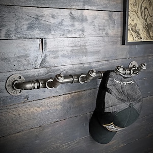 Industrial style metal wall coat rack. Hooks for entryway or bathroom. Industrial and vintage interior decoration