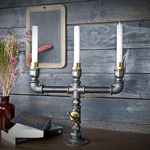 Industrial style cast iron and brass candlestick. Interior decoration, tableware