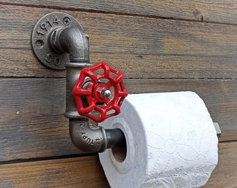 Industrial-style toilet paper holder. Metal toilet paper holder, vintage and steampunk interior decoration