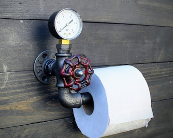 Original toilet paper holder. Metal toilet paper roll holder. Industrial interior decoration.
