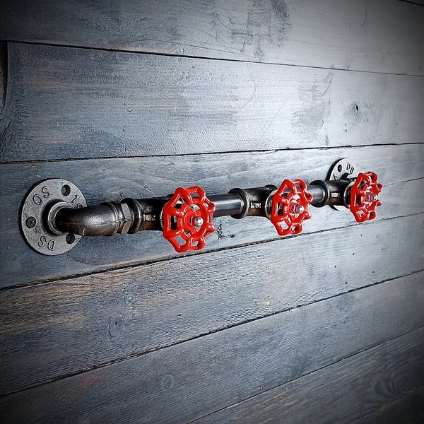 Industrial style wall coat rack. Cast iron valve hooks. Vintage, steampunk interior decoration. Entrance to house, loft