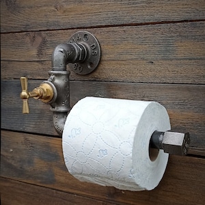 Industrial toilet paper dispenser. Original toilet roll holder, vintage interior decoration, plumbing, brass faucet