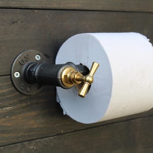 Industrial toilet paper holder. Original toilet paper roll holder, Vintage interior decoration.