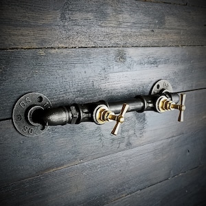 Industrial-style metal wall-mounted coat rack. Hooks and pegs. Industrial and vintage interior design.
