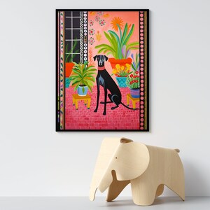 May include: A black dog with a blue collar sits in a room with a pink tiled floor and many potted plants. The plants are in colorful pots and the room has a black framed window with a view of a green lawn.