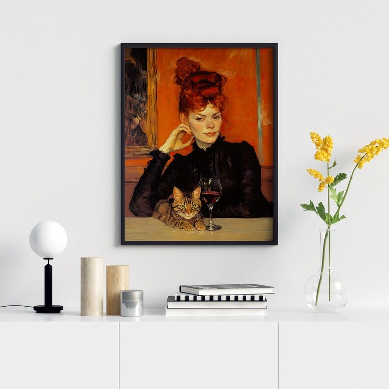 May include: A framed painting depicting a woman with red hair seated at a table with a cat and a glass of red wine. The woman is wearing a black dress and the cat is brown and white.