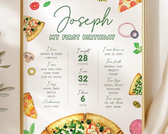 May include: A framed print with a gold border, featuring the name "Joseph" and "My First Birthday." The print includes details like weight (28 pounds), height (32 inches), and favorite things, with pizza slice illustrations.
