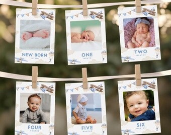May include: A set of six blue and white photo cards with a baby boy in each photo. The cards are decorated with a blue airplane, clouds, and a banner. The cards are labeled with the baby's age in months, from "New Born" to "Six Months".
