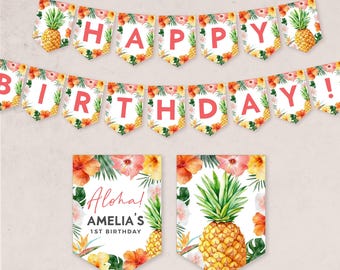 May include: A tropical-themed birthday banner with the words "Happy Birthday!" in pink letters. The banner is decorated with pineapples, hibiscus flowers, and green leaves. There are also two matching signs with the text "Aloha! Amelia's 1st Birthday" and a pineapple.