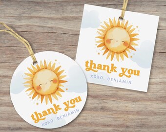 May include: Two white gift tags with a watercolor sun design. The sun has a smiling face and is surrounded by yellow rays. The text "thank you" is written in orange script, with "XOXO. BENJAMIN" below. One tag is round, the other square.