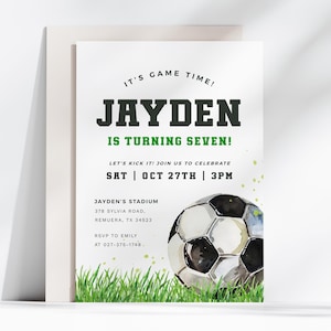 May include: A green and white soccer-themed birthday invitation for a boy turning seven. The invitation features a watercolor illustration of a soccer ball on a green grass field. The text on the invitation reads "It's Game Time! Jayden is turning seven! Let's kick it! Join us to celebrate Sat | Oct 27th | 3pm Jayden's Stadium 378 Sylvia Road, Remuera, TX 34523 RSVP to Emily at 027-375-1748."