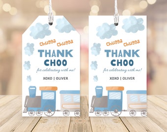 May include: Two blue and white train-themed thank you tags with the text "Chugga Chugga Thank Choo for celebrating with me! XOXO | Oliver" printed on them.