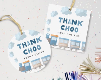 May include: Two round and square thank you tags with a blue train and clouds. The text on the tags reads "Thank Choo xoxo | Oliver".