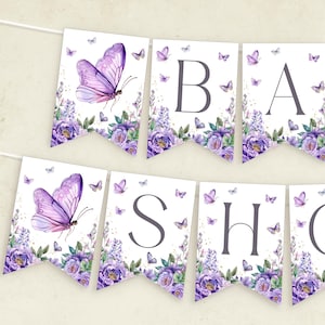 Peut inclure: Une guirlande de fanions épelant "BABY SHOWER". Chaque fanion présente un papillon aquarelle et un motif floral dans des tons de violet et de lavande. De petits papillons sont dispersés autour des fanions.