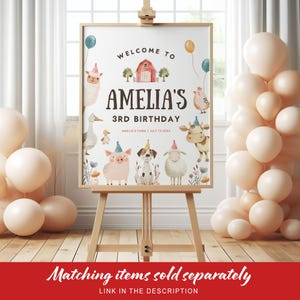May include: A framed sign on an easel announces "Welcome to Amelia's 3rd Birthday." The sign features illustrations of farm animals, balloons, and a red barn. The text "Amelia's Farm | July 13, 20XX" is also included. Peach-colored balloons are clustered nearby.