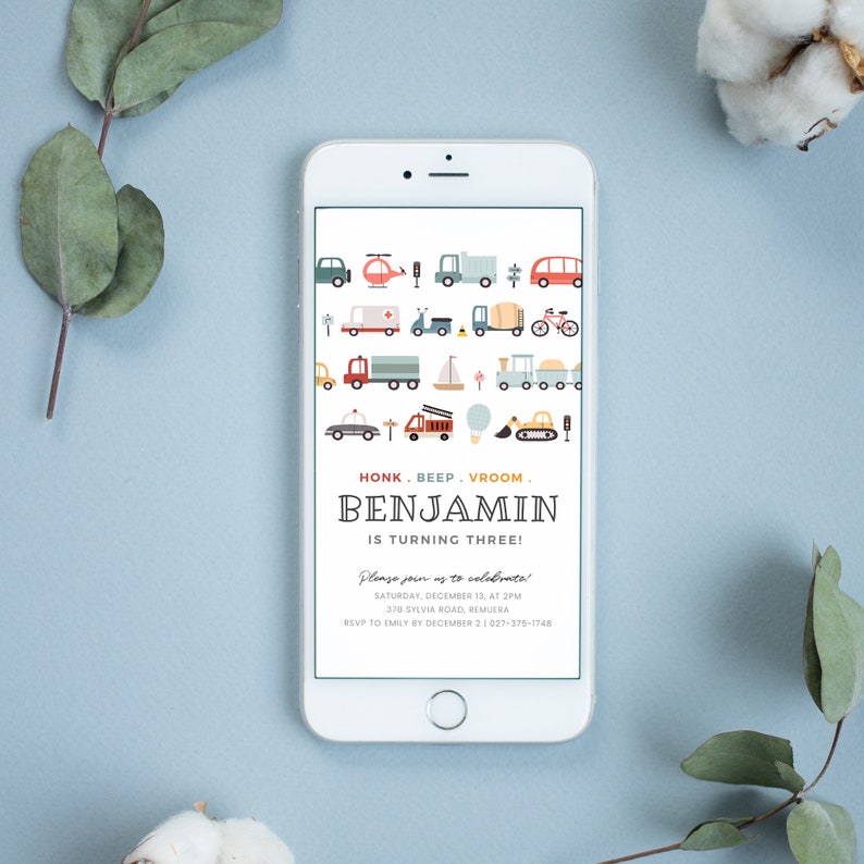 May include: A blue and white smartphone screen displaying a birthday invitation for a boy named Benjamin turning three. The invitation features a colorful illustration of various vehicles, including cars, trucks, helicopters, and a hot air balloon. The text on the invitation reads "Honk. Beep. Vroom. Benjamin is turning three! Please join us to celebrate! Saturday, December 13, at 2pm 370 Sylvia Road, Remuera RSVP to Emily by December 2 (027)-375-1748"