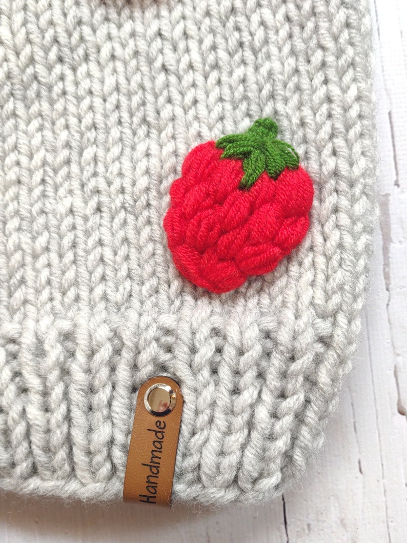 Knitting detail of luxury wool strawberry cardigan.