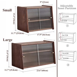 May include: Two wooden display cabinets with glass doors and adjustable shelves. The smaller cabinet measures 13.4 inches tall, 11.7 inches wide, and 9 inches deep. The larger cabinet measures 13.4 inches tall, 11.7 inches wide, and 23.6 inches deep. The cabinets have a dark wood finish and brass handles.