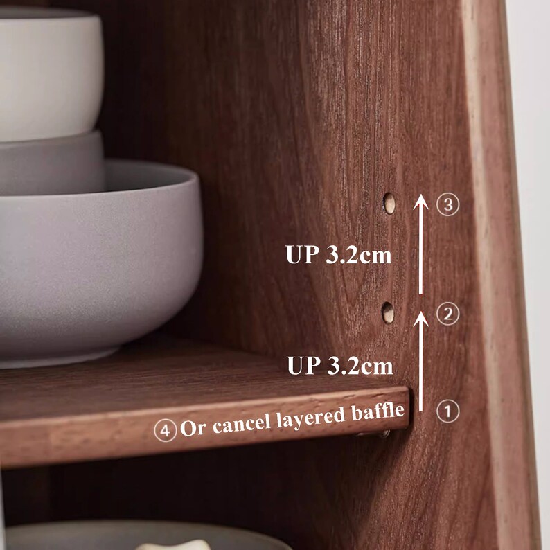 May include: Close-up of a wooden shelf with three holes drilled into the side. The holes are labeled 1, 2, and 3. The text "UP 3.2cm" is written twice, indicating the height of the shelf. The text "Or cancel layered baffle" is written below the holes.