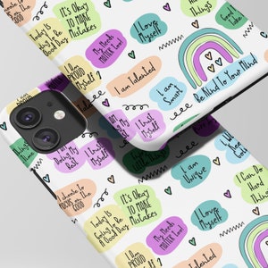 May include: White phone case with a colorful rainbow design and positive affirmations like "I love myself", "I am talented", and "Be kind to your mind".