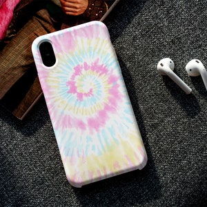 May include: A white phone case with a pink, blue, and yellow tie-dye pattern.