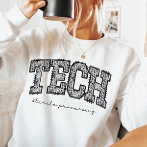 May include: White sweatshirt with a black and white leopard print graphic that says "TECH sterile processing".