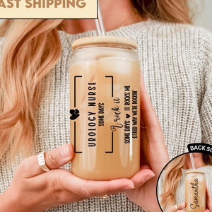 May include: A clear glass tumbler with a bamboo lid and a straw. The tumbler has a black graphic that says "Urology Nurse" with the text "Some days I rock it, some days it rocks me, either way we're rockin".