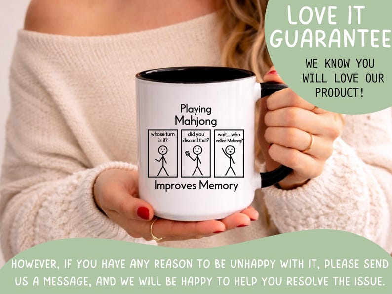 May include: White ceramic mug with a black interior and handle. The mug features the text "Playing Mahjong Improves Memory" with stick figure illustrations and the phrases "whose turn is it?", "did you discard that?", and "wait... who called Mahjong?"