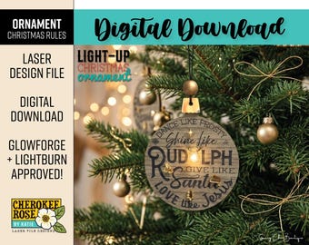 May include: A round, light-colored wooden Christmas ornament featuring a light-up center and black text that reads: Dance like Frosty, Shine like Rudolph, Give like Santa, Love like Jesus. The ornament hangs from a black string with a gold bead.