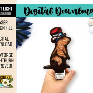 May include: A wooden night light featuring a groundhog wearing a top hat with red, white, and blue accents. The design is a laser design file, digital download, approved for Glowforge and Lightburn. The text "Digital Download" is also visible.
