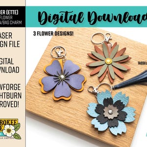 May include: Three layered flower keychains or bag charms made of leather-like material in purple, orange, rust, green, light blue, and black. Each features a metal keyring and lobster clasp. A dark blue leather-like tassel is included with the designs.