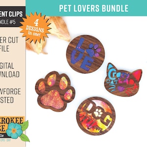 Puede incluir: Cuatro clips de ventilación de coche de madera cortados con láser con diseños coloridos. Los diseños incluyen una huella de pata, la palabra "LOVE" con una huella de pata, una cara de gato con las palabras "Crazy Cat Lady" y una huella de pata con la palabra "Dog Dad".
